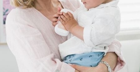 Woman holds her young son.
