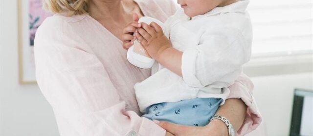 Woman holds her young son.
