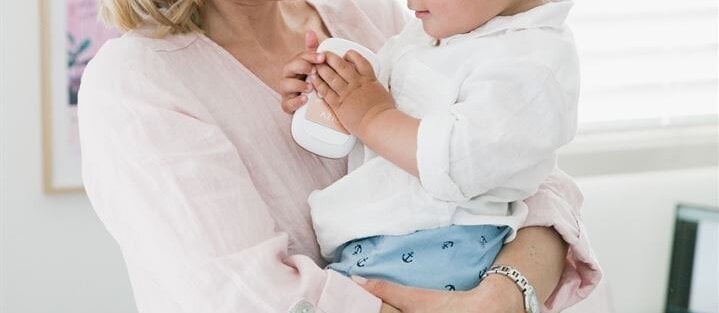 Woman holds her young son.