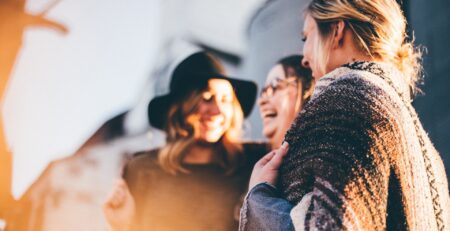 Photo of women celebrating, laughing.
